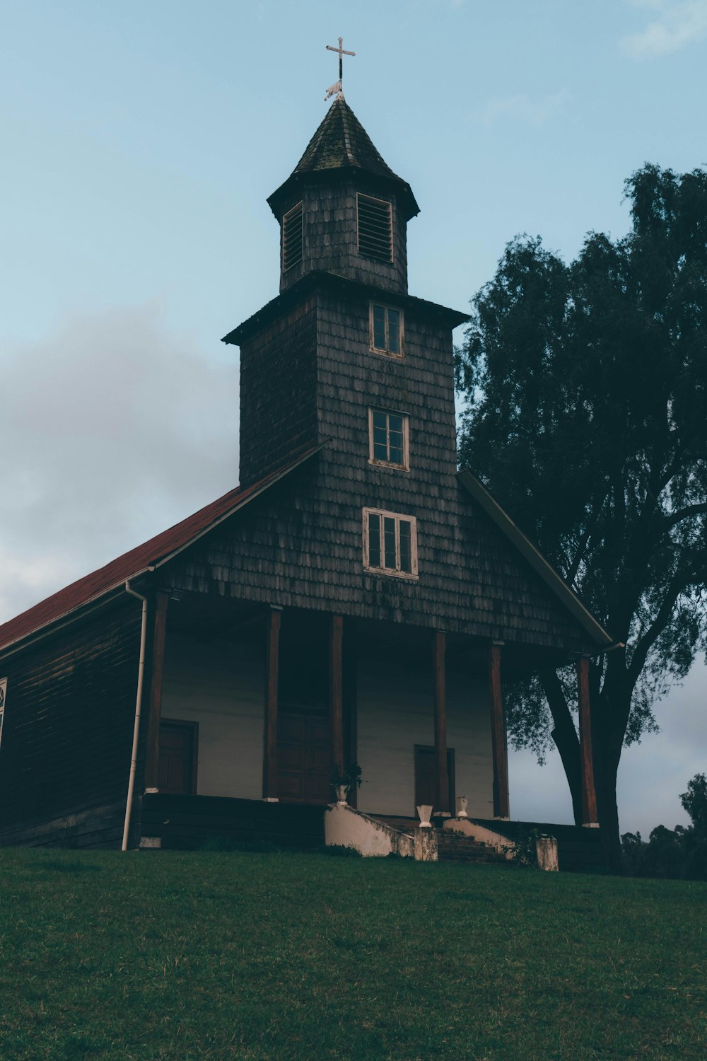 a church with a steeple and a cross on top