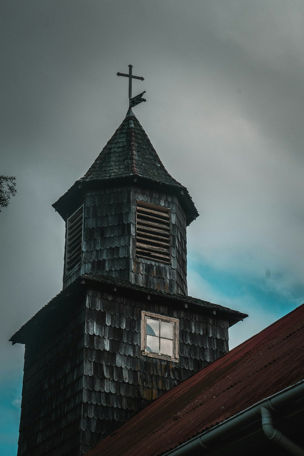 a church steeple with a cross on top of it