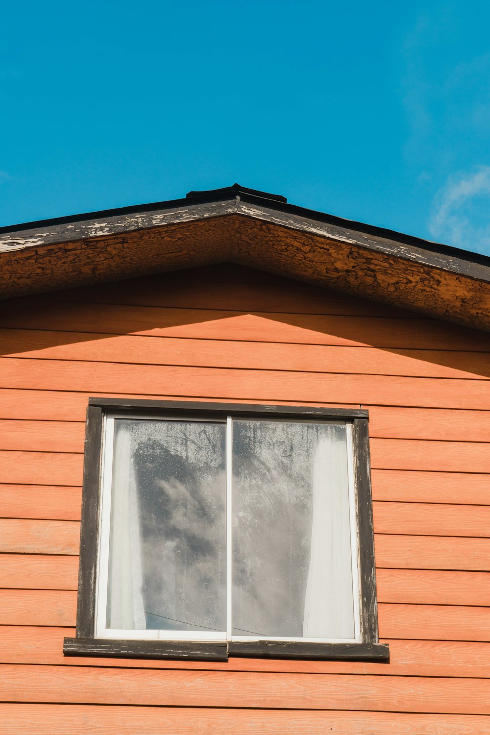 a window on a house with a sky background