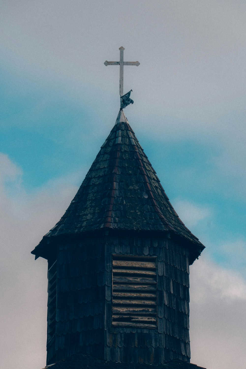 a church steeple with a cross on top