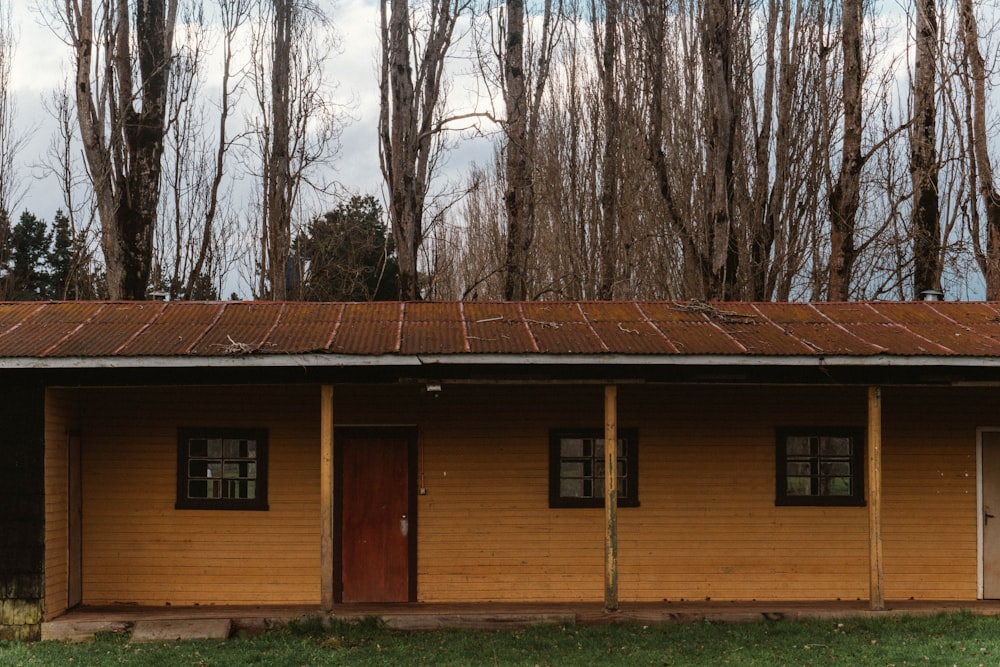a small building with two doors and a brown roof