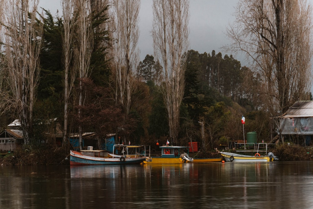 a group of boats floating on top of a lake