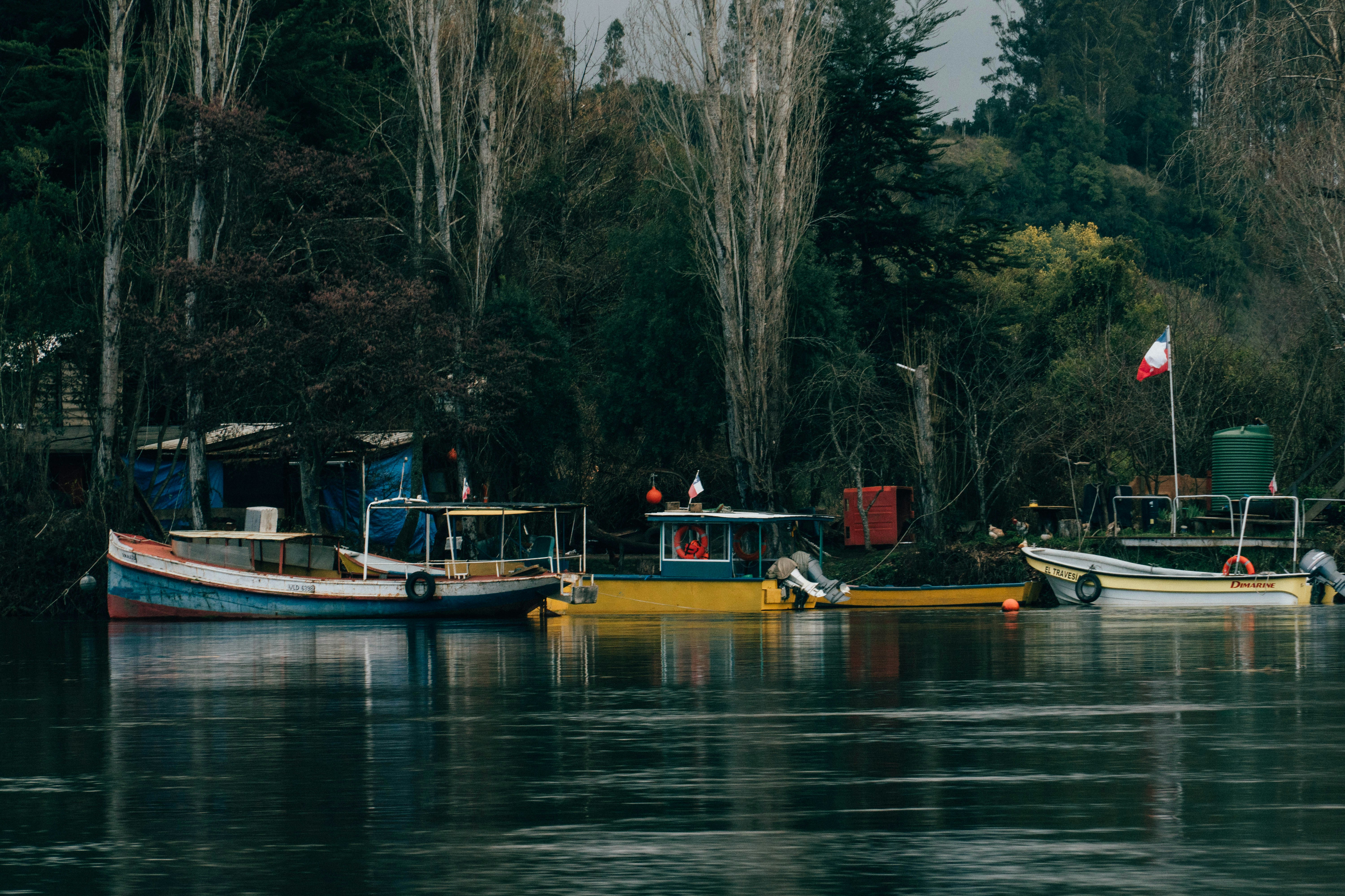 a group of boats floating on top of a lake