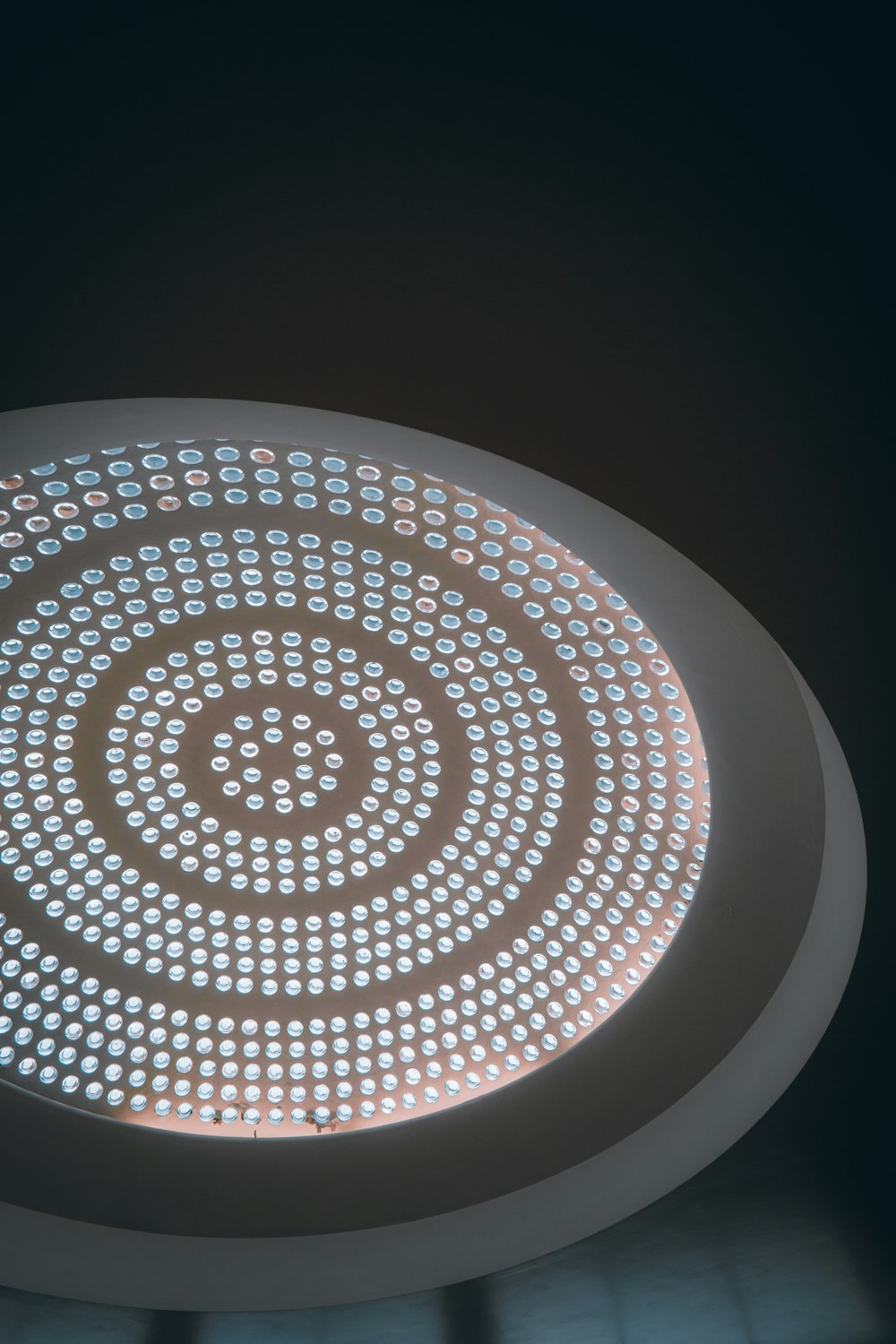 a circular light fixture in a dark room