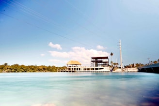 A serene vacant lot in Florida with clear skies and nearby utilities visible.