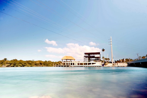 A serene vacant lot in Florida with clear skies and nearby utilities visible.