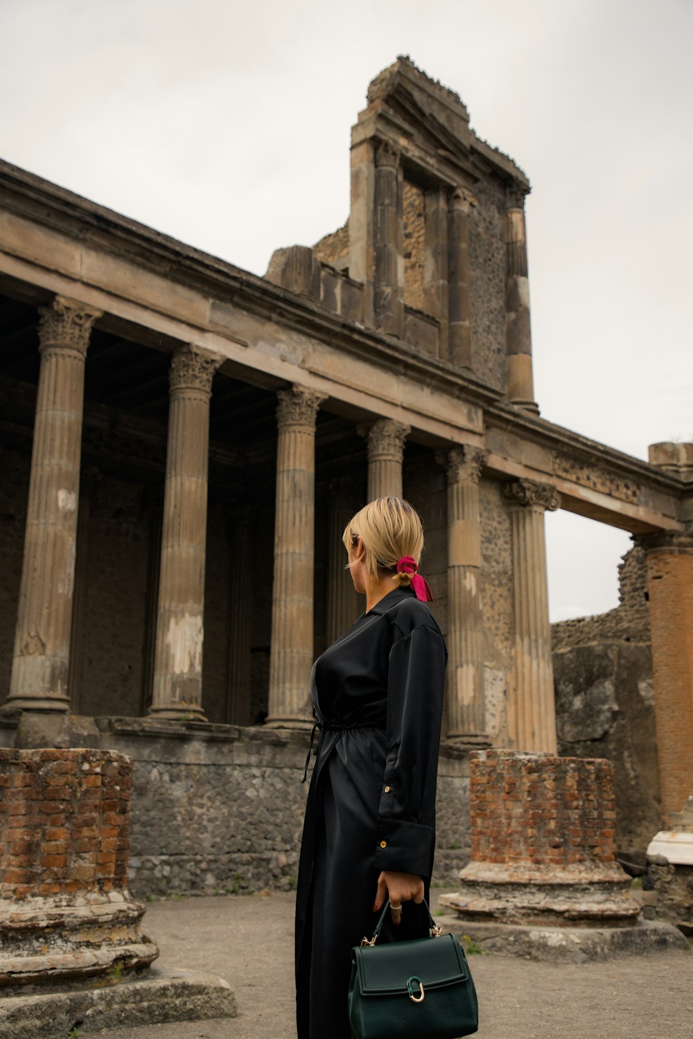a woman standing in front of an old building
