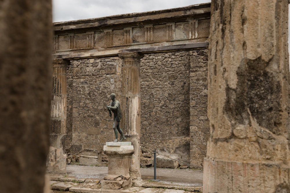 a statue of a man is in between two pillars