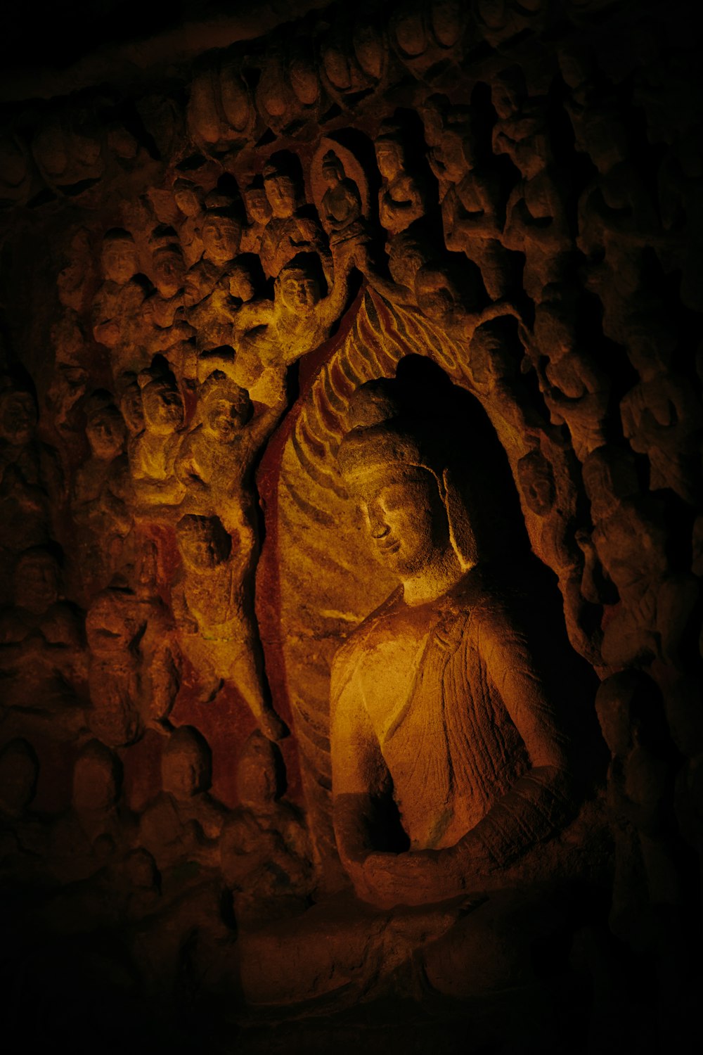 a statue of a buddha in a cave