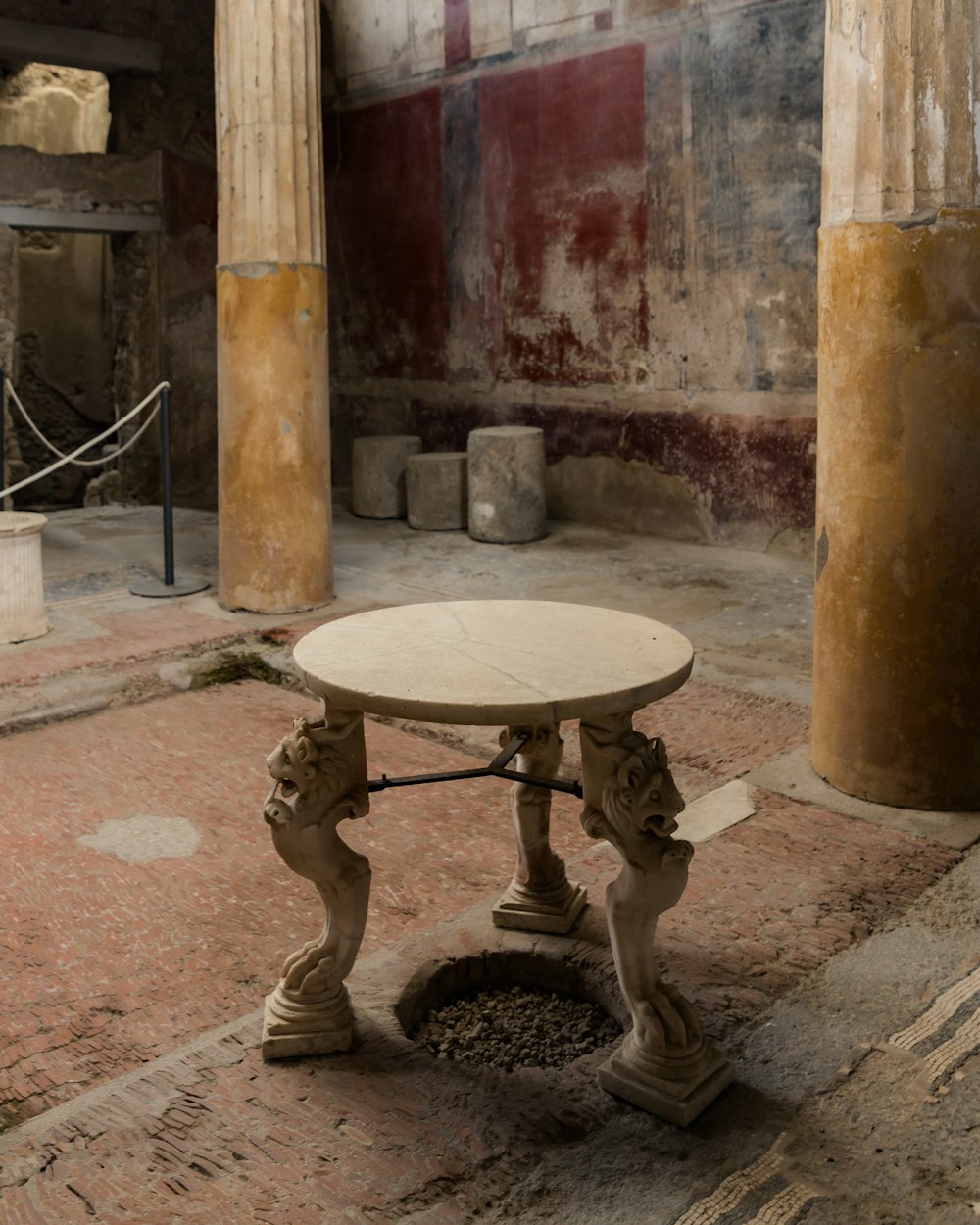 a small table in a room with columns
