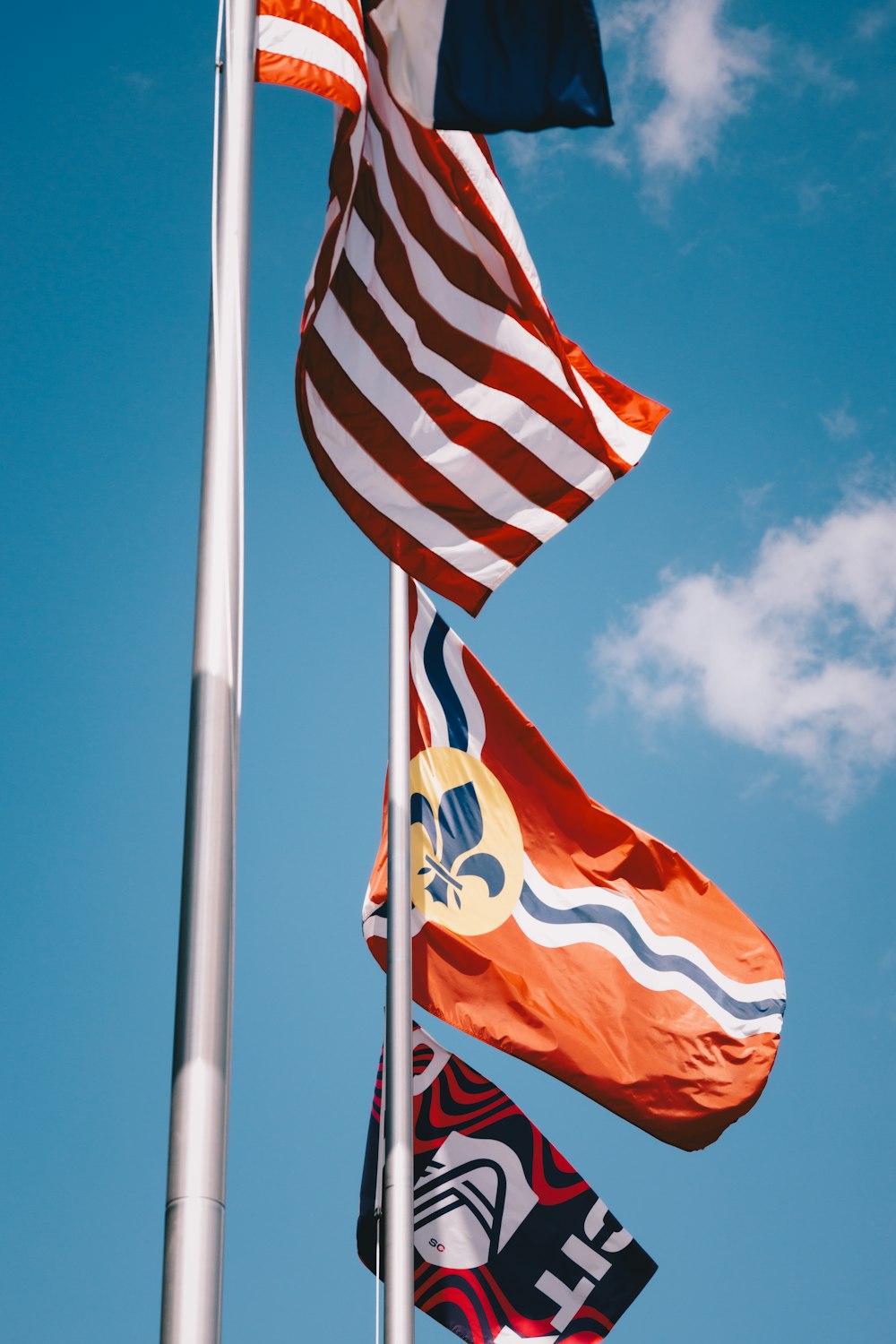 a group of flags flying in the wind