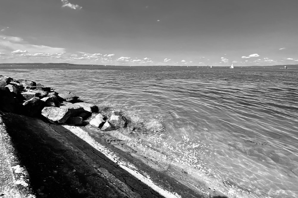 a black and white photo of water and rocks