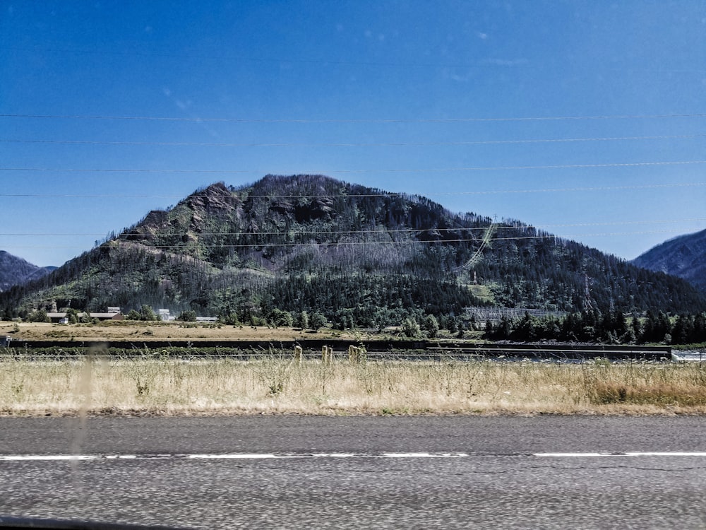 a road with a mountain in the background