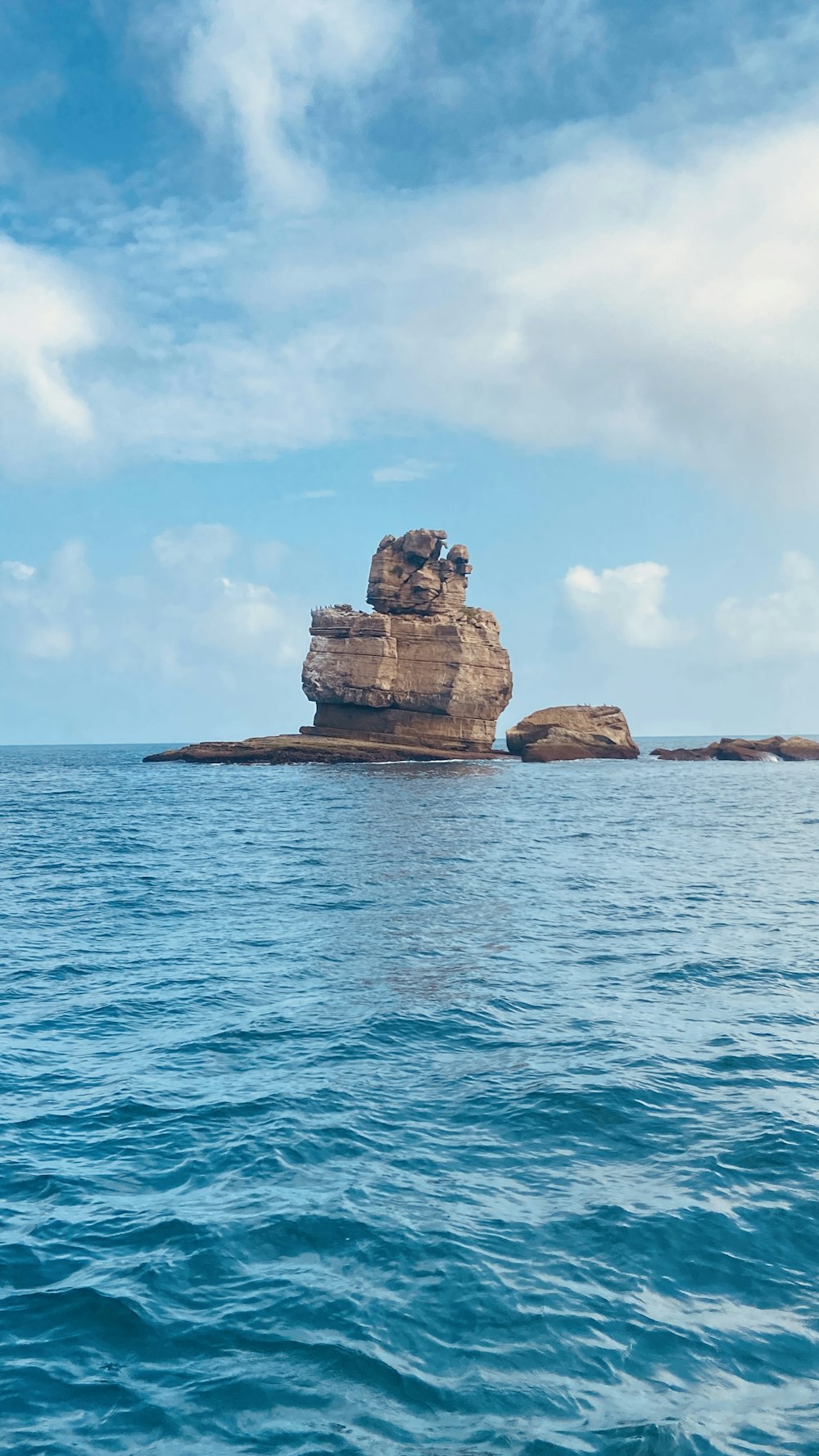 a rock outcropping in the middle of the ocean