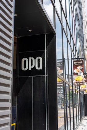 Modern commercial building facade featuring sleek ACM panels and illuminated 3D letters.