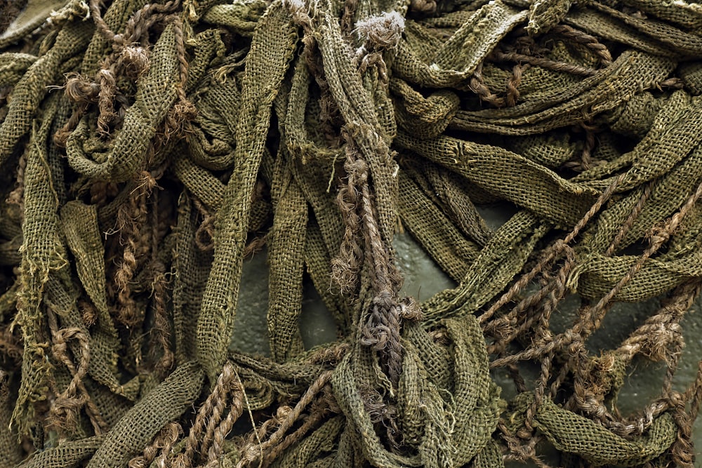 a pile of green rope sitting on top of a wooden table
