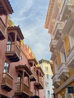 A traveler exploring a historic street lined with colorful buildings.