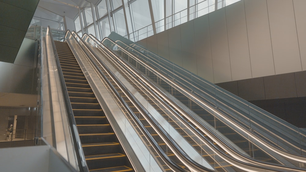 an escalator in a building with metal railings