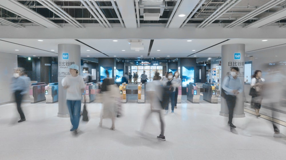 a blurry photo of people walking in a mall