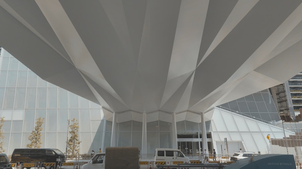 a large white structure with a truck underneath it