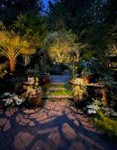 An elegant stone pathway winding through a serene garden with soft lighting at dusk.