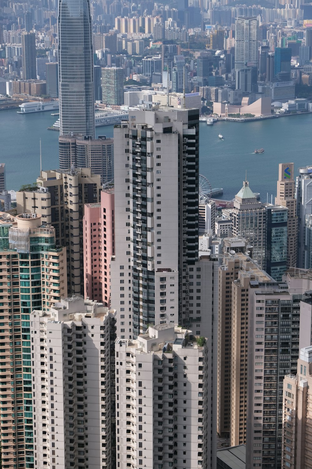 a city with tall buildings and a body of water in the background