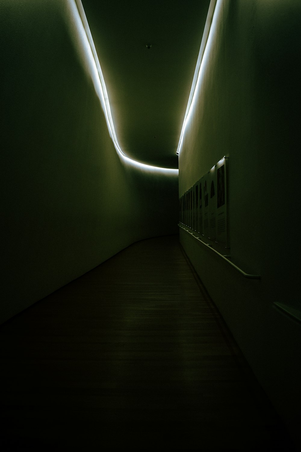 a dimly lit hallway with lights on the walls