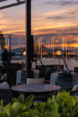 Drone shot capturing a vibrant restaurant terrace at sunset.