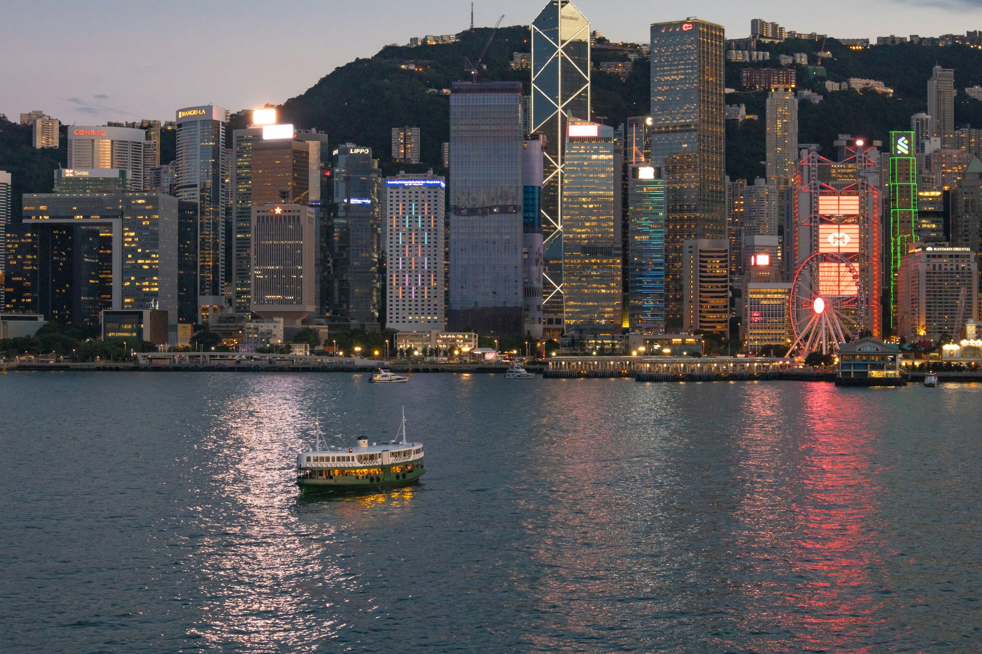 a boat in the water in front of a large city