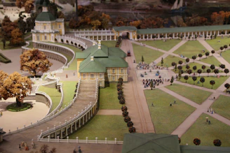 A detailed 3D model of a landscaped garden featuring pathways, plants, and water features.