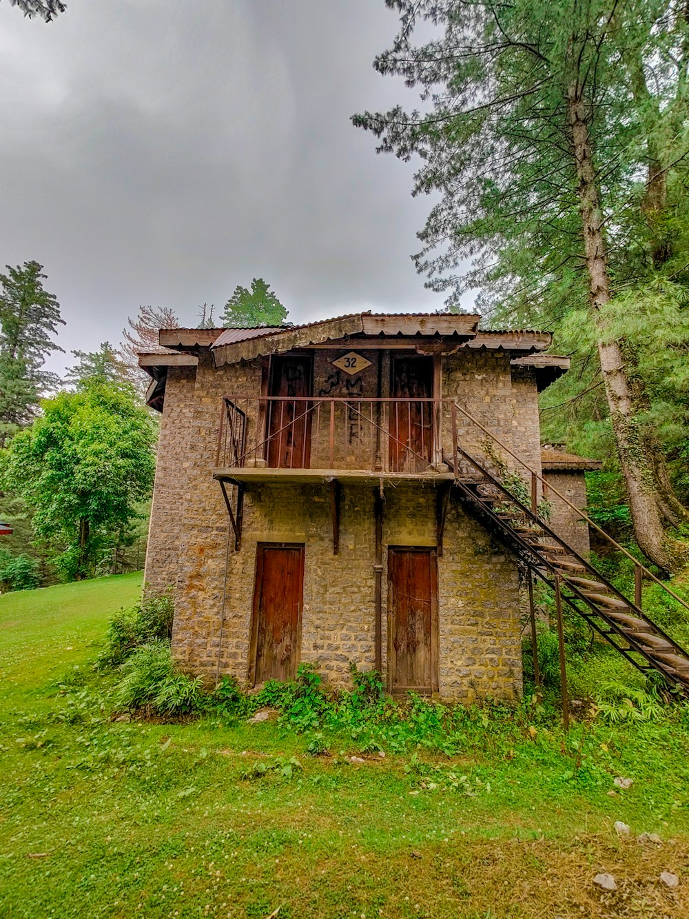 an old stone building with a wooden balcony