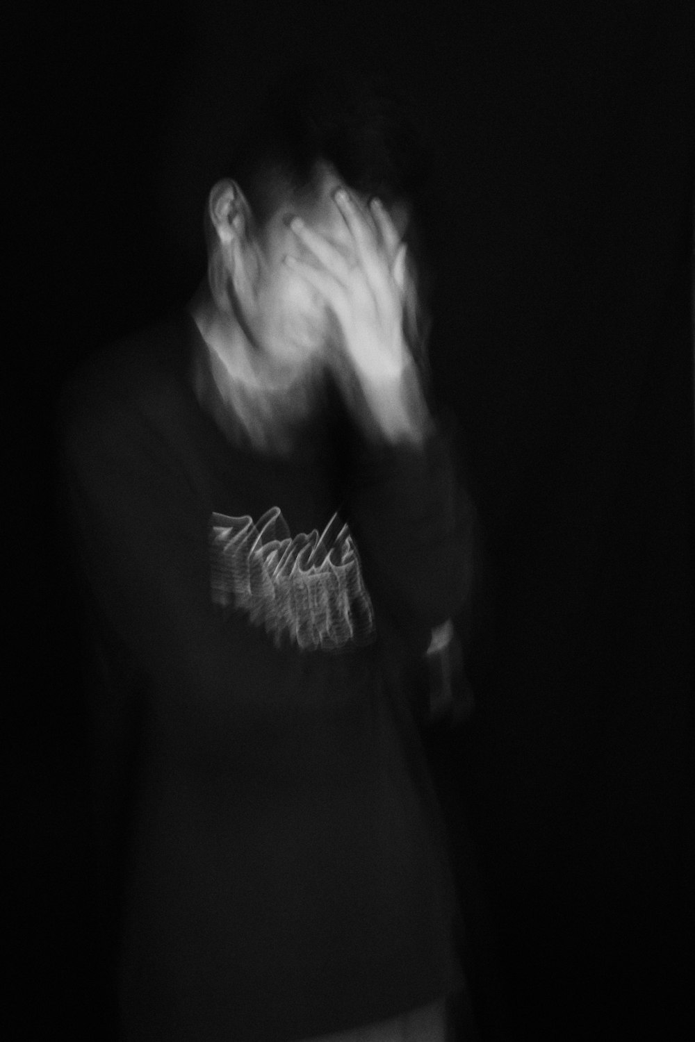 a blurry photo of a person standing in the dark