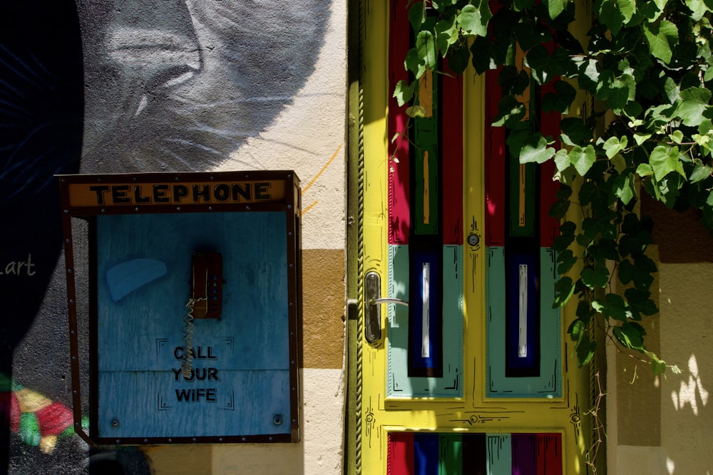 a telephone booth with a cat painted on it