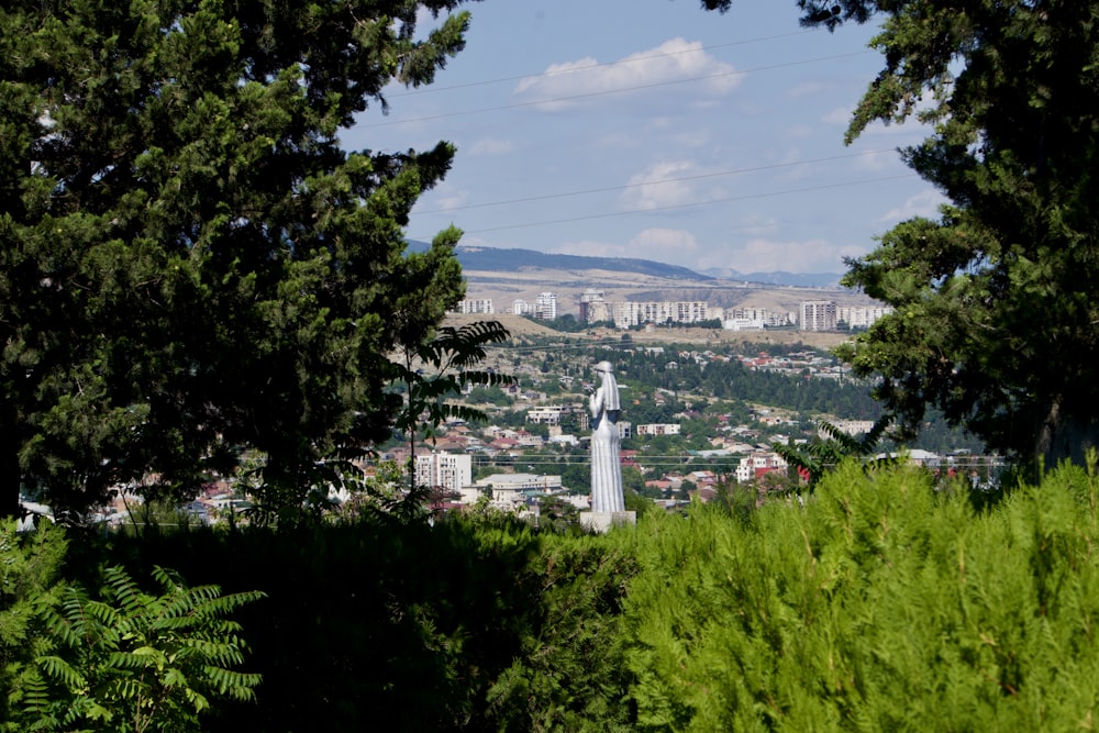 a view of a city from behind some trees