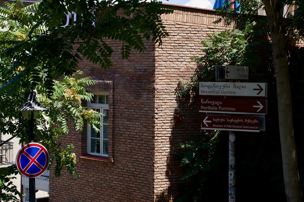 a street sign in front of a brick building