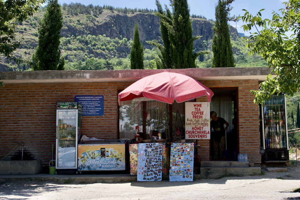 a store with a red umbrella outside of it