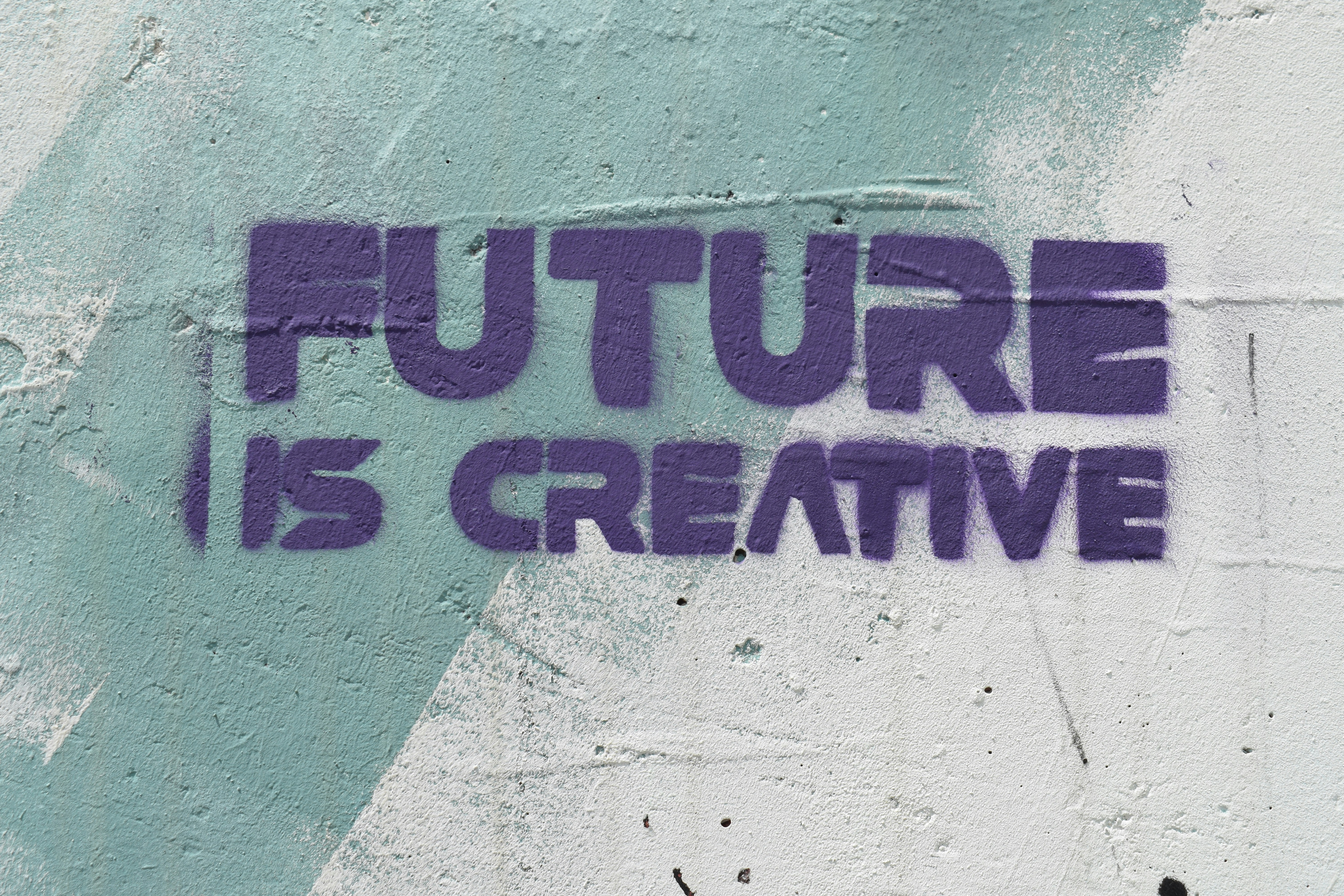 a graffiti on a wall that says, future is creative