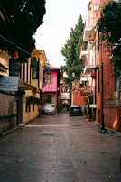 A charming narrow street lined with colorful buildings and cafes.