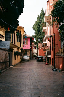 A charming narrow street lined with colorful buildings and cafes.