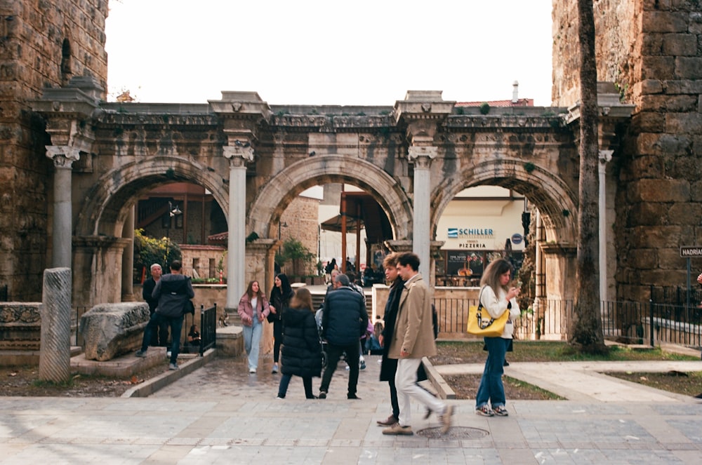 a group of people walking around a stone courtyard