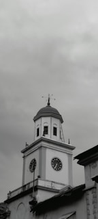 a black and white photo of a clock tower