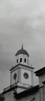 a black and white photo of a clock tower