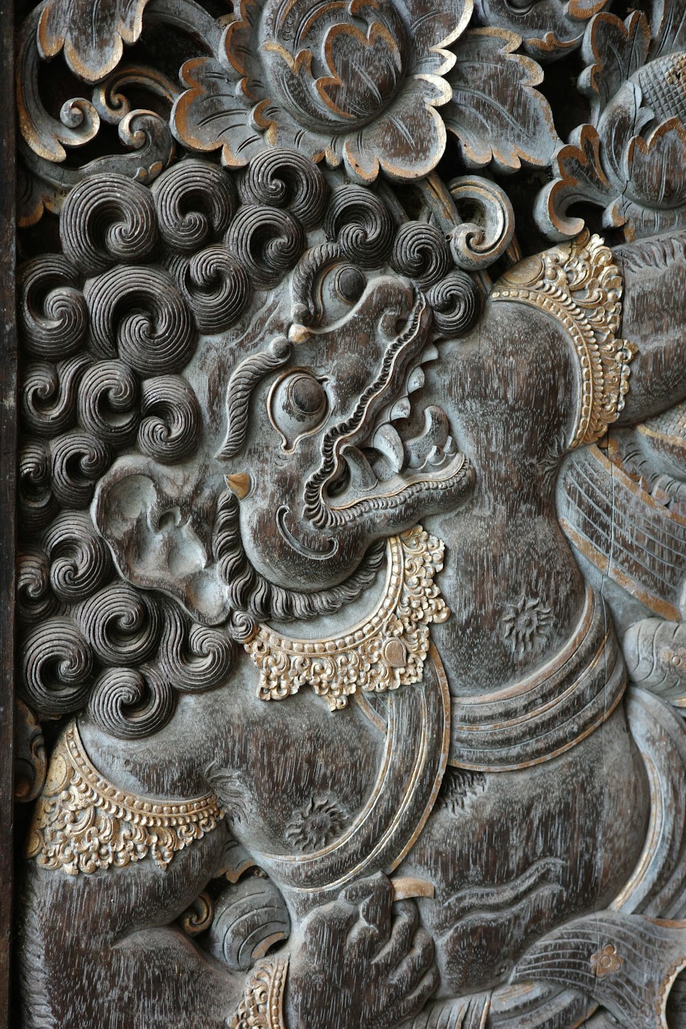 a carving of a woman with a flower in her hair