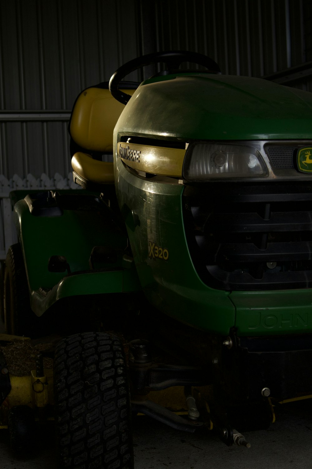 a large green tractor parked in a garage
