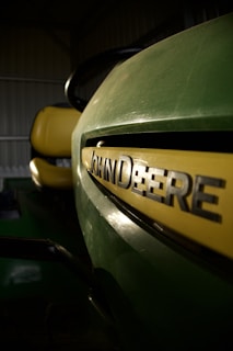 a close up of a green and yellow vehicle