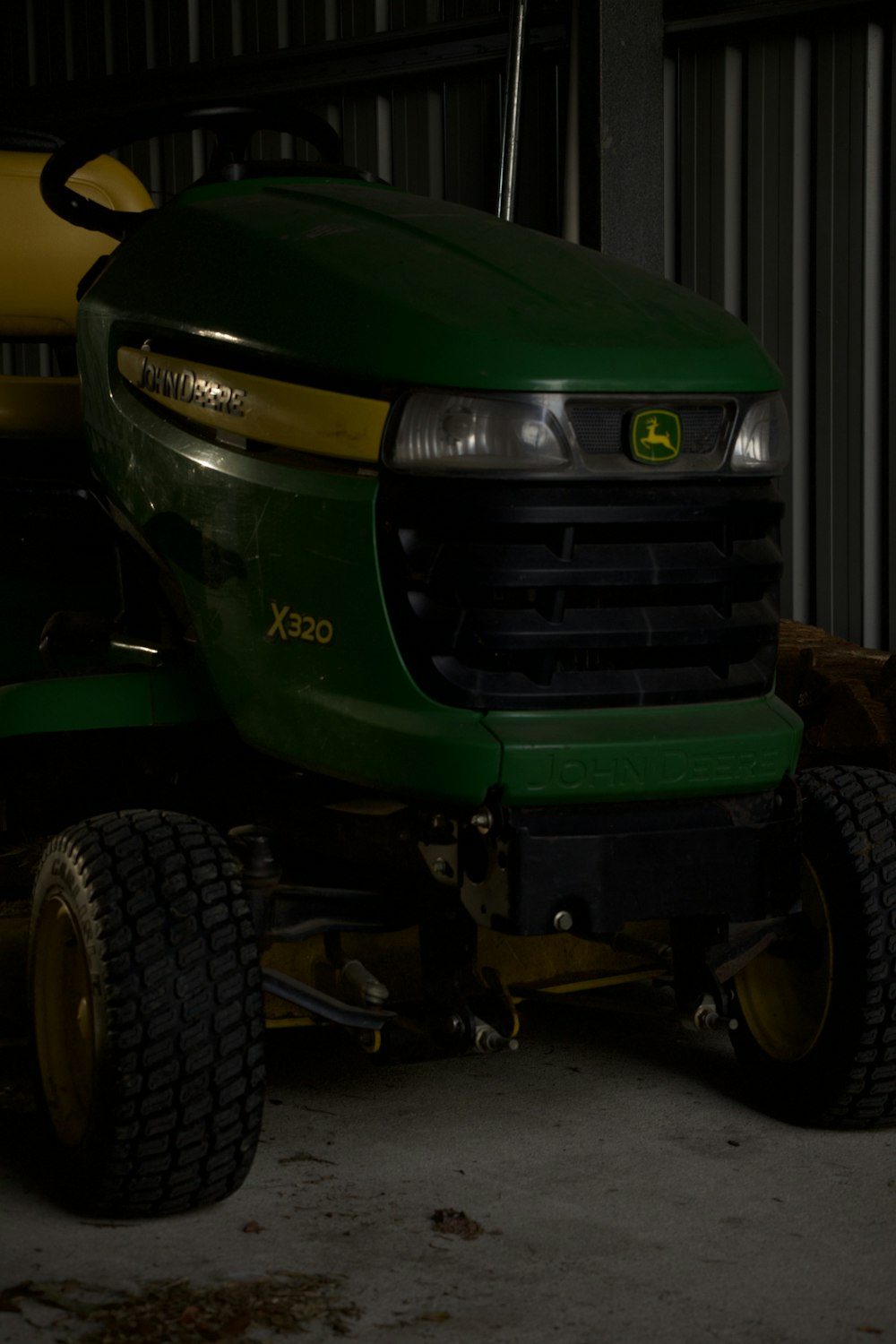 a large green tractor parked in a garage