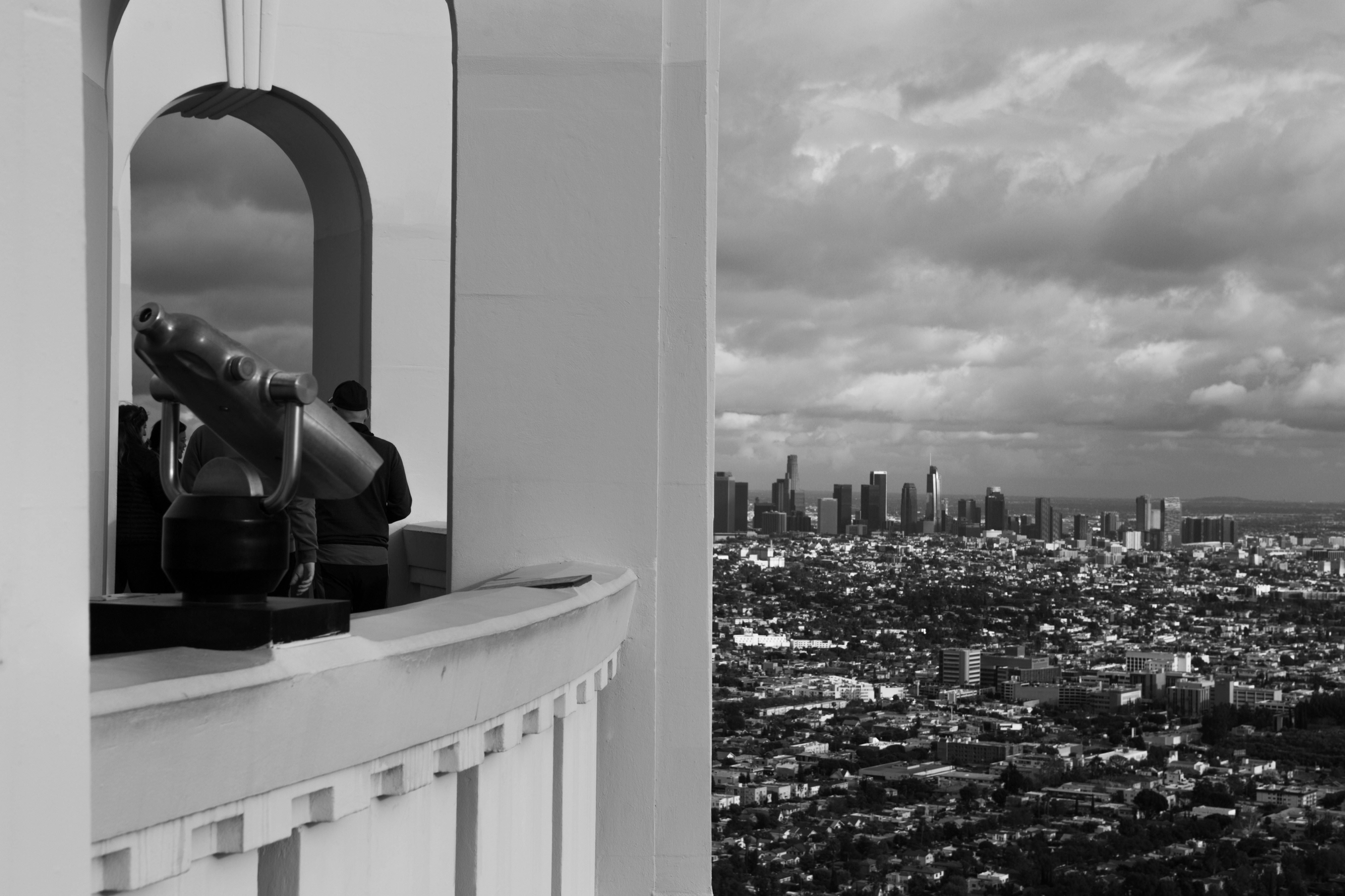 A black and white photo of a city from a window