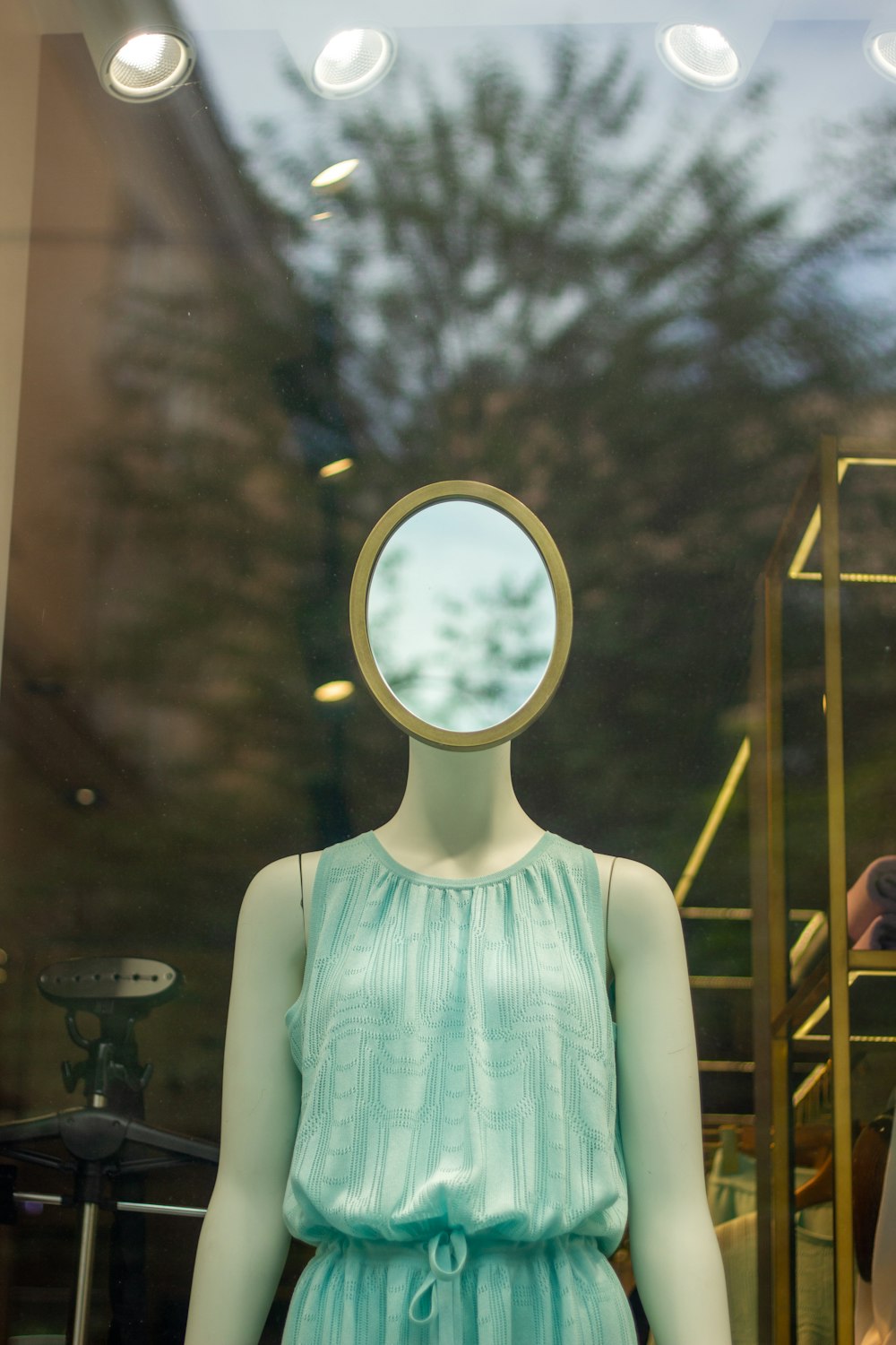 a mannequin with a mirror on it's head