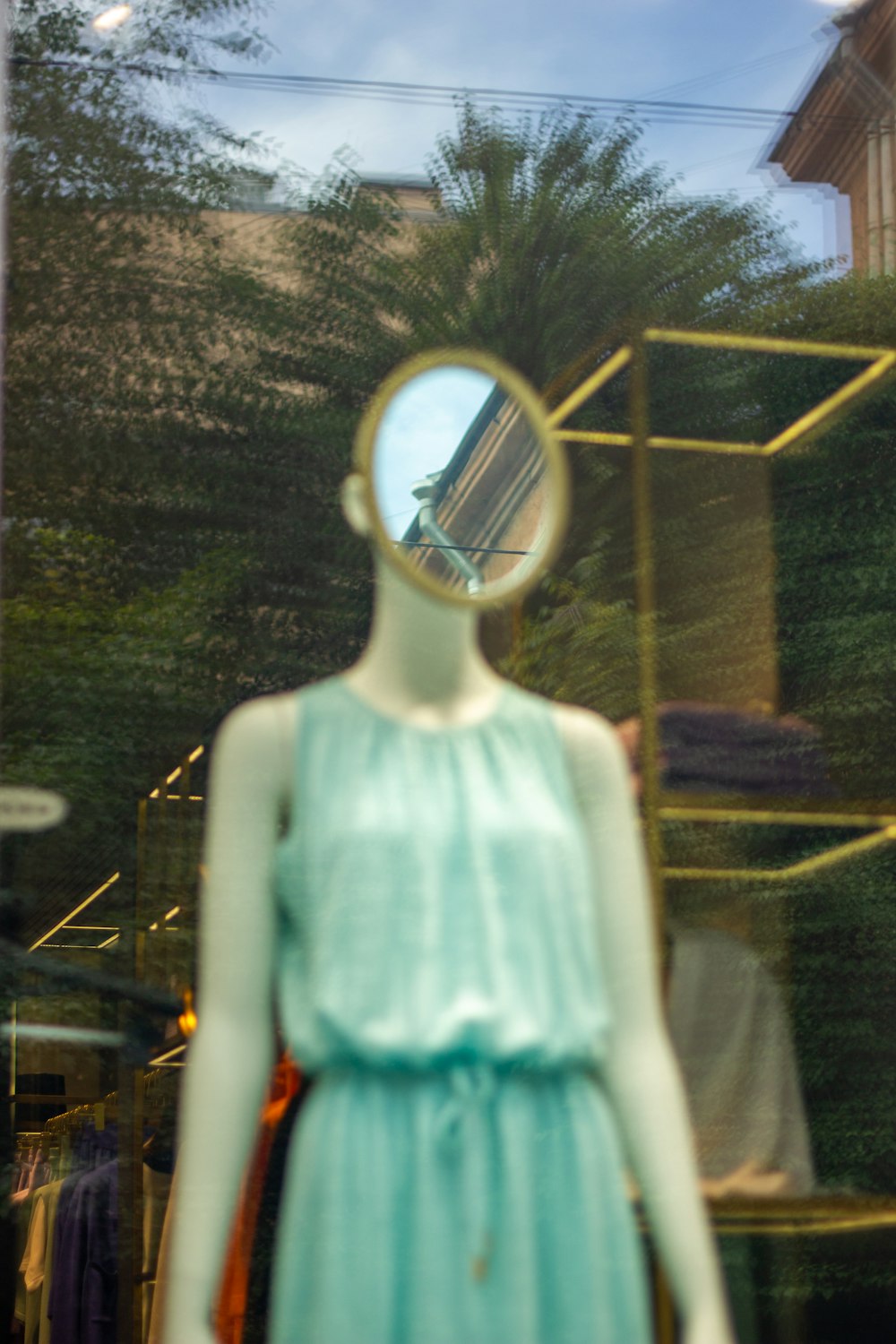 a mannequin with a mirror on its head