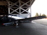 Completed wing section with control surfaces attached, resting in the hangar